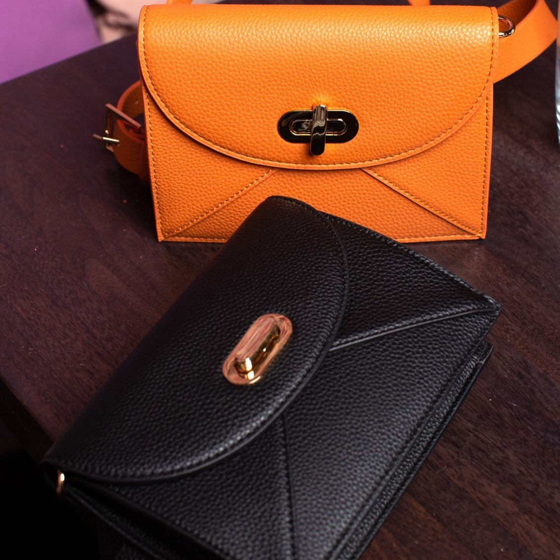 Bird's eye view of both chameleon colors, both orange camel and black sand on a table